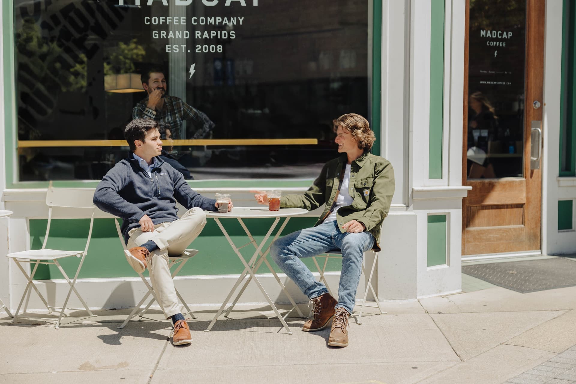 Chris Villaire meeting with a client outside Madcap Coffee in downtown Grand Rapids