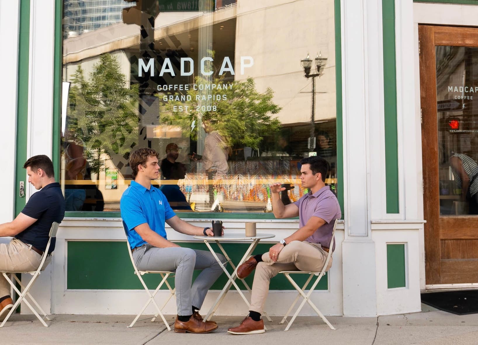 Chris Villaire meeting with a client outside Madcap Coffee in downtown Grand Rapids