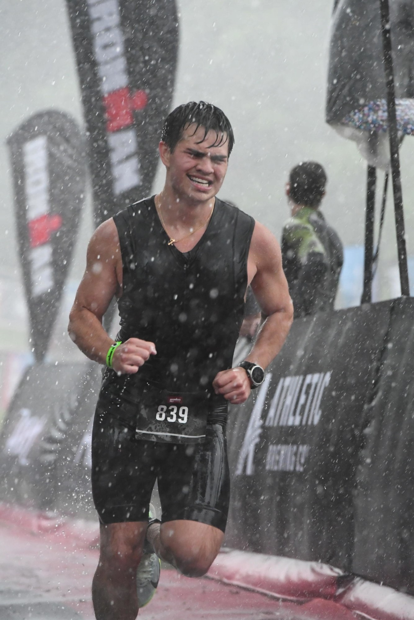Chris Villaire running through the rain at the Ironman 70.3 finish